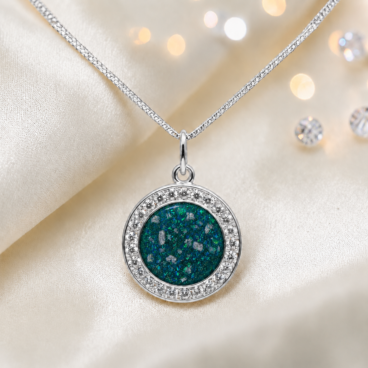 Zosma round memorial locket with CZ stones in teal mist, handcrafted in Lancashire UK  by Keepsake Memorial Jewellery