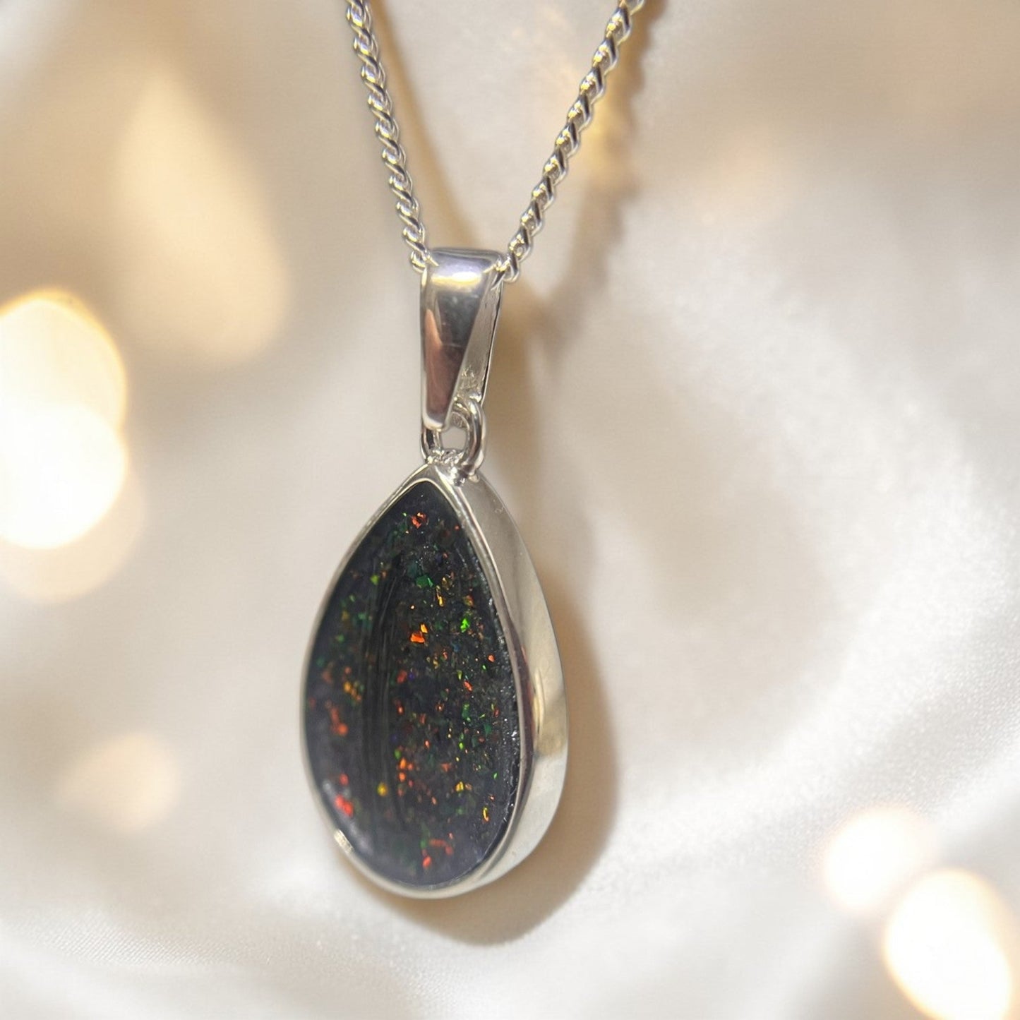 side view of silver hair memorial pendant, handcrafted in uk