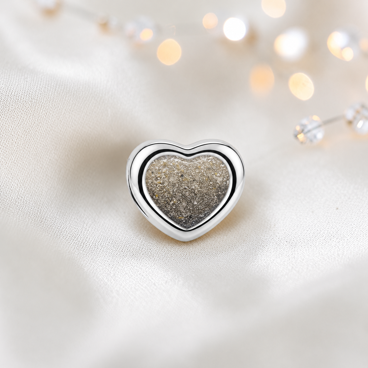 Natural ash sterling silver peaceful heart ashes memorial charm, handcrafted in Lancashire by keepsake memorial