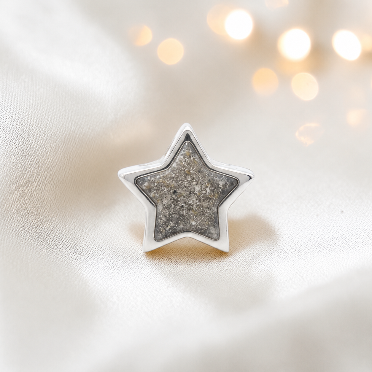 Natural ash sterling silver star ashes memorial charm, handcrafted in Lancashire by keepsake memorial