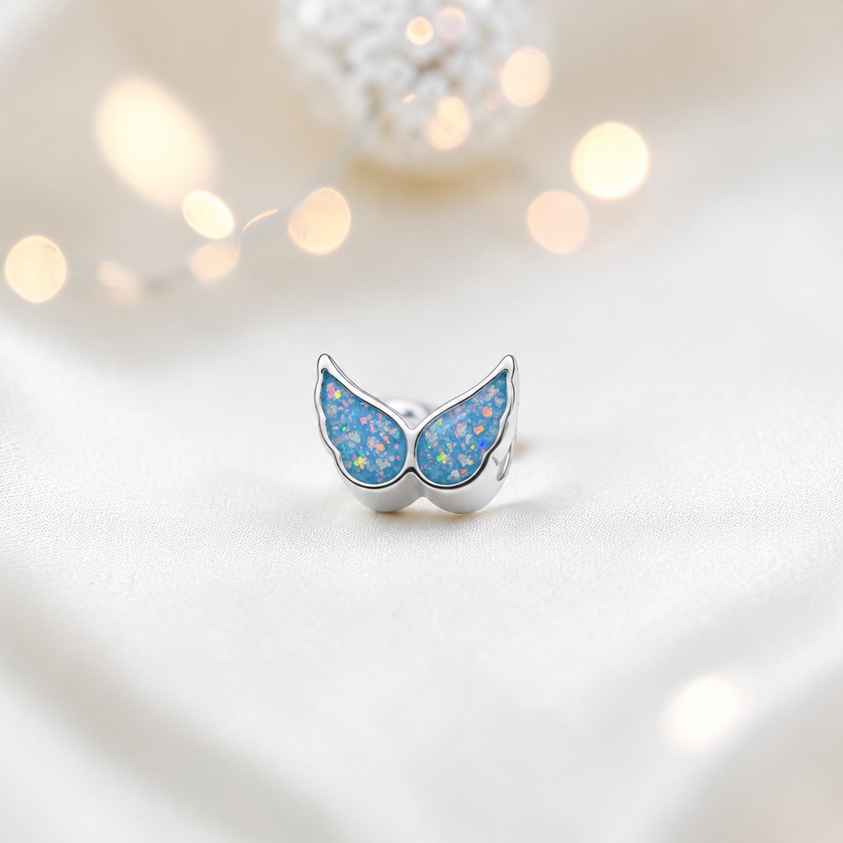 Baby blue sterling silver angel wing ashes memorial charm, handcrafted in Lancashire by keepsake memorial