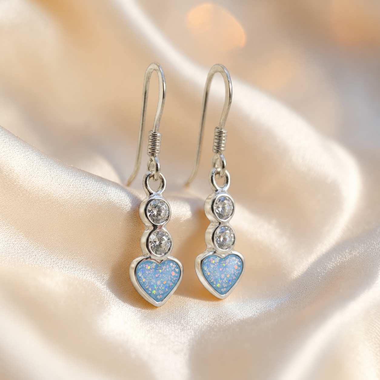 Pleione Earrings — silver heart drop ashes memorial earrings in Baby Blue resin, handcrafted in Lancashire, UK