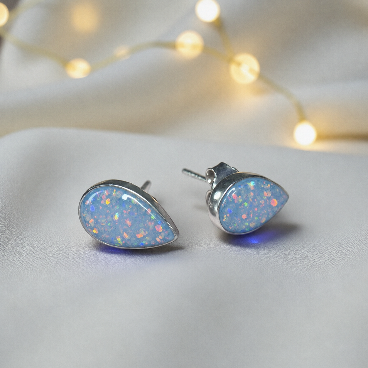 Pure Radiance memorial earrings in Baby Blue opal — sterling silver, handcrafted in Lancashire, UK