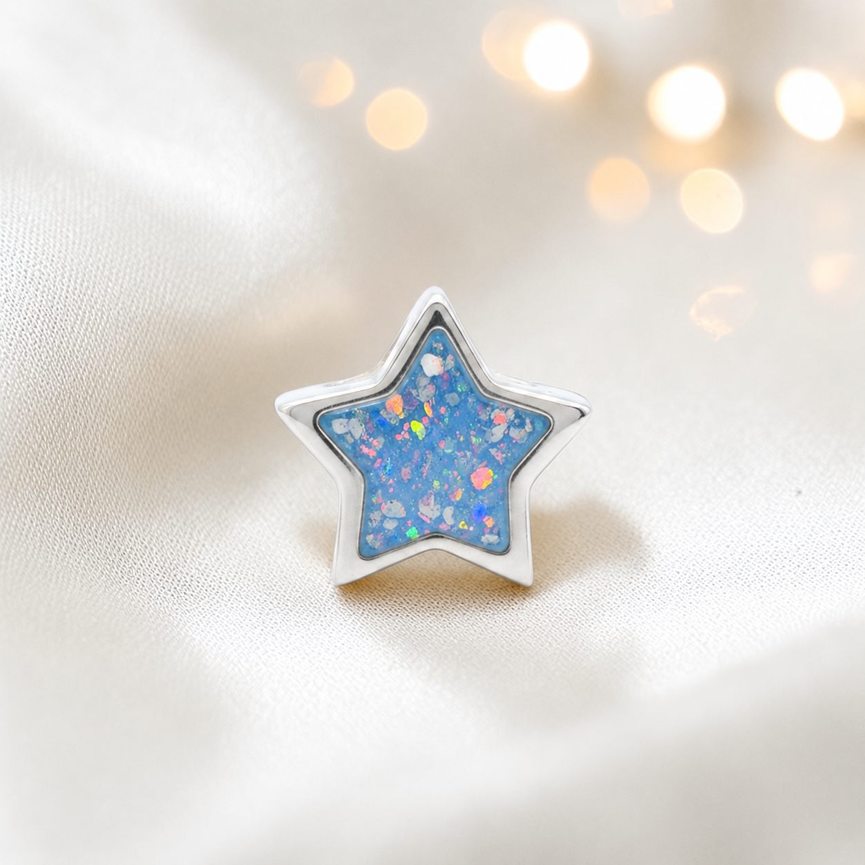 Baby blue sterling silver star ashes memorial charm, handcrafted in Lancashire by keepsake memorial