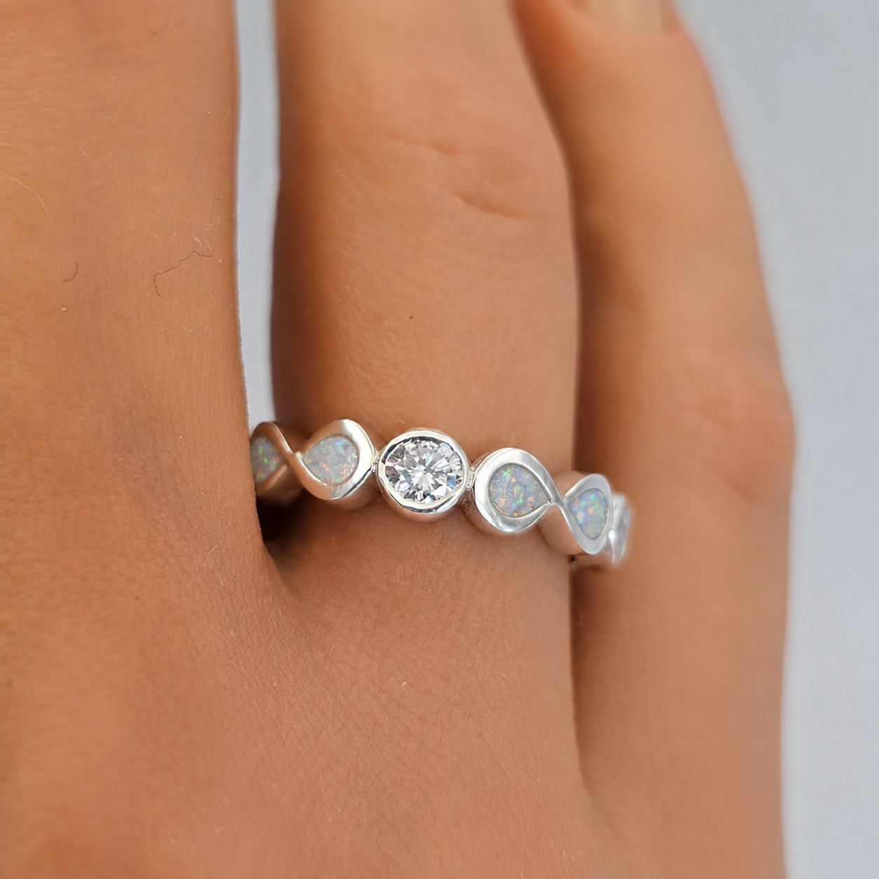 Keepsake Memorial Silver Celestina Ashes Ring in Snow opal on models hand— handcrafted in Lancashire, UK