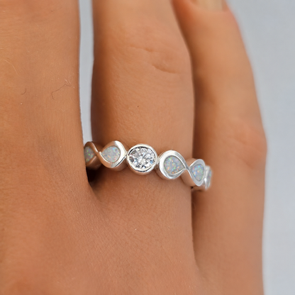Keepsake Memorial Silver Celestina Ashes Ring in Snow opal on models hand— handcrafted in Lancashire, UK
