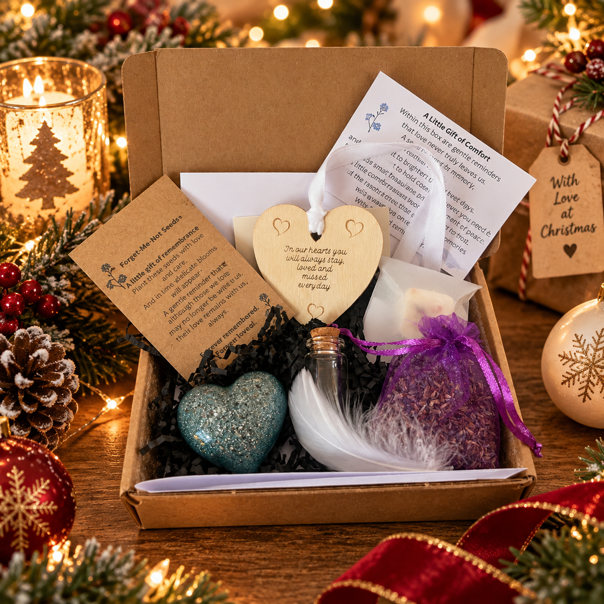 Keepsake memorial little box of comforts gift set in festive Christmas packaging, including pocket heart, glass ashes bottle, engraved wooden heart, dried lavender, wax melt, forget-me-not seeds and comfort poem