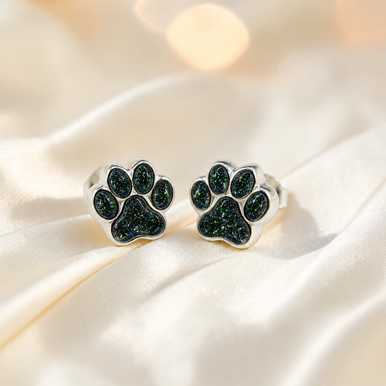 Cleo pet paw memorial ear studs in Black Flame opal — sterling silver, handcrafted in Lancashire, UK