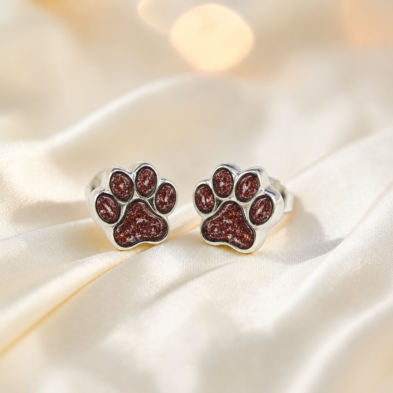 Cleo pet paw memorial ear studs in Ruby Red opal — sterling silver, handcrafted in Lancashire, UK
