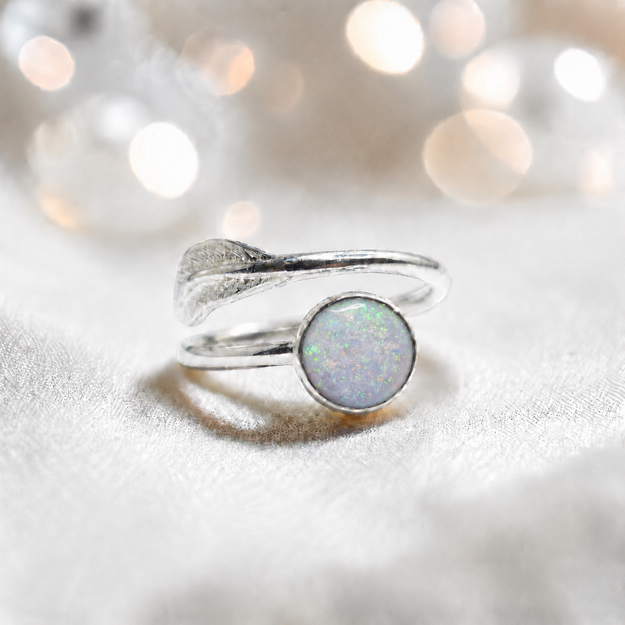 Feather Whisper Ring — silver feather ashes memorial ring, in white snow, handcrafted in Lancashire, UK
