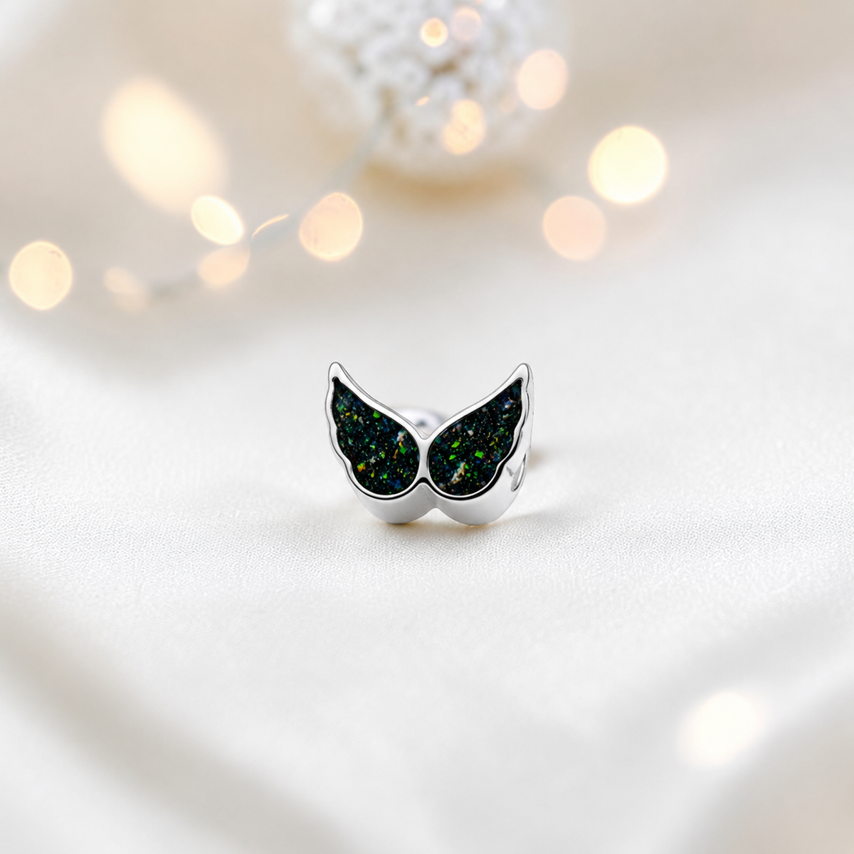 Black flame sterling silver angel wing ashes memorial charm, handcrafted in Lancashire by keepsake memorial
