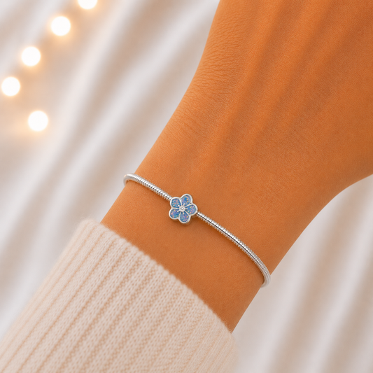 Baby blue sterling silver forget me not ashes memorial charm, handcrafted in Lancashire by keepsake memorial