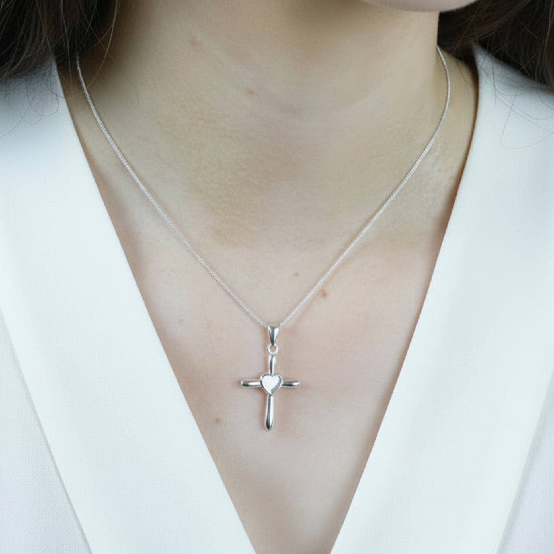 silver heart cross pendant on model uk