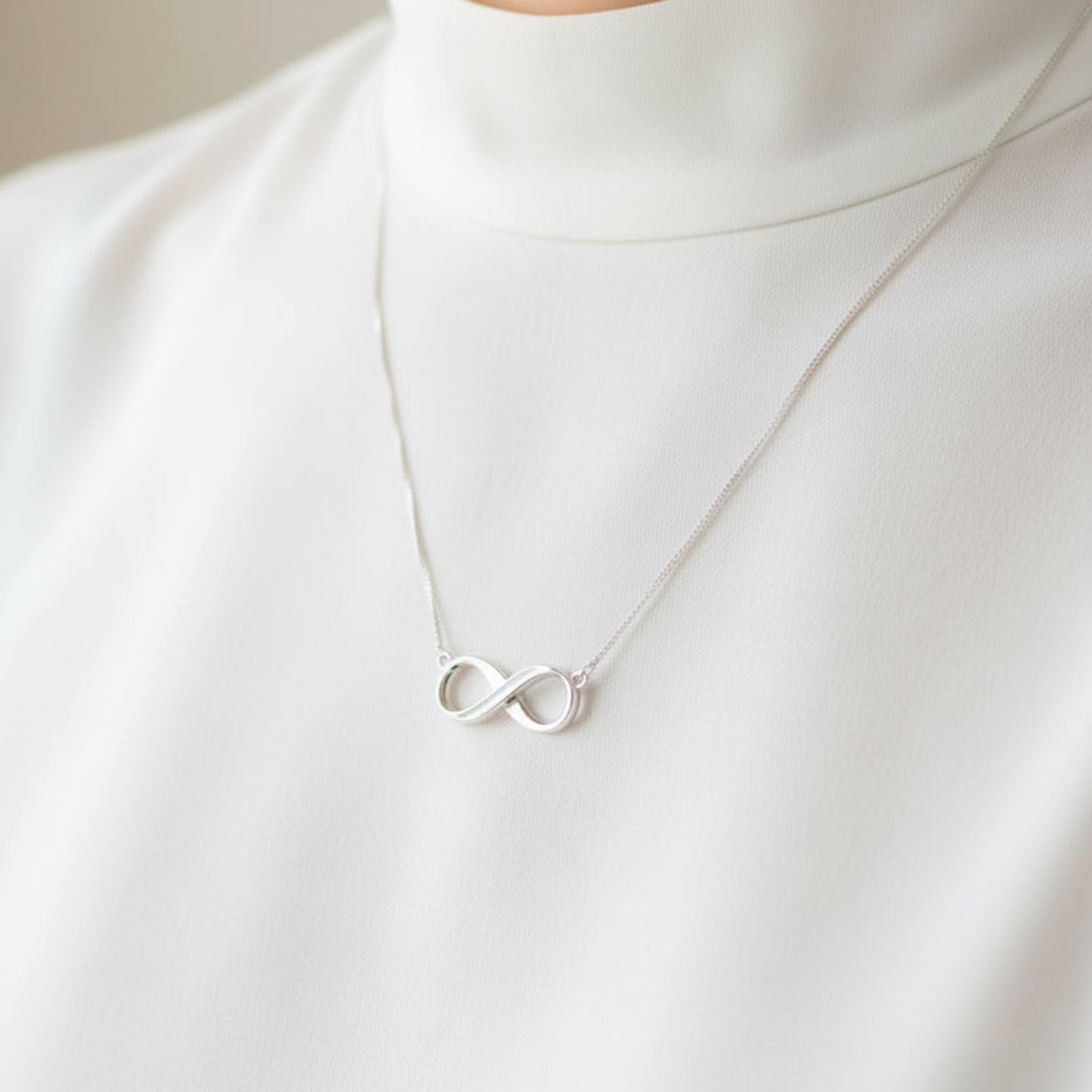 silver ashes infinity necklace on neck handcrafted in rossendale