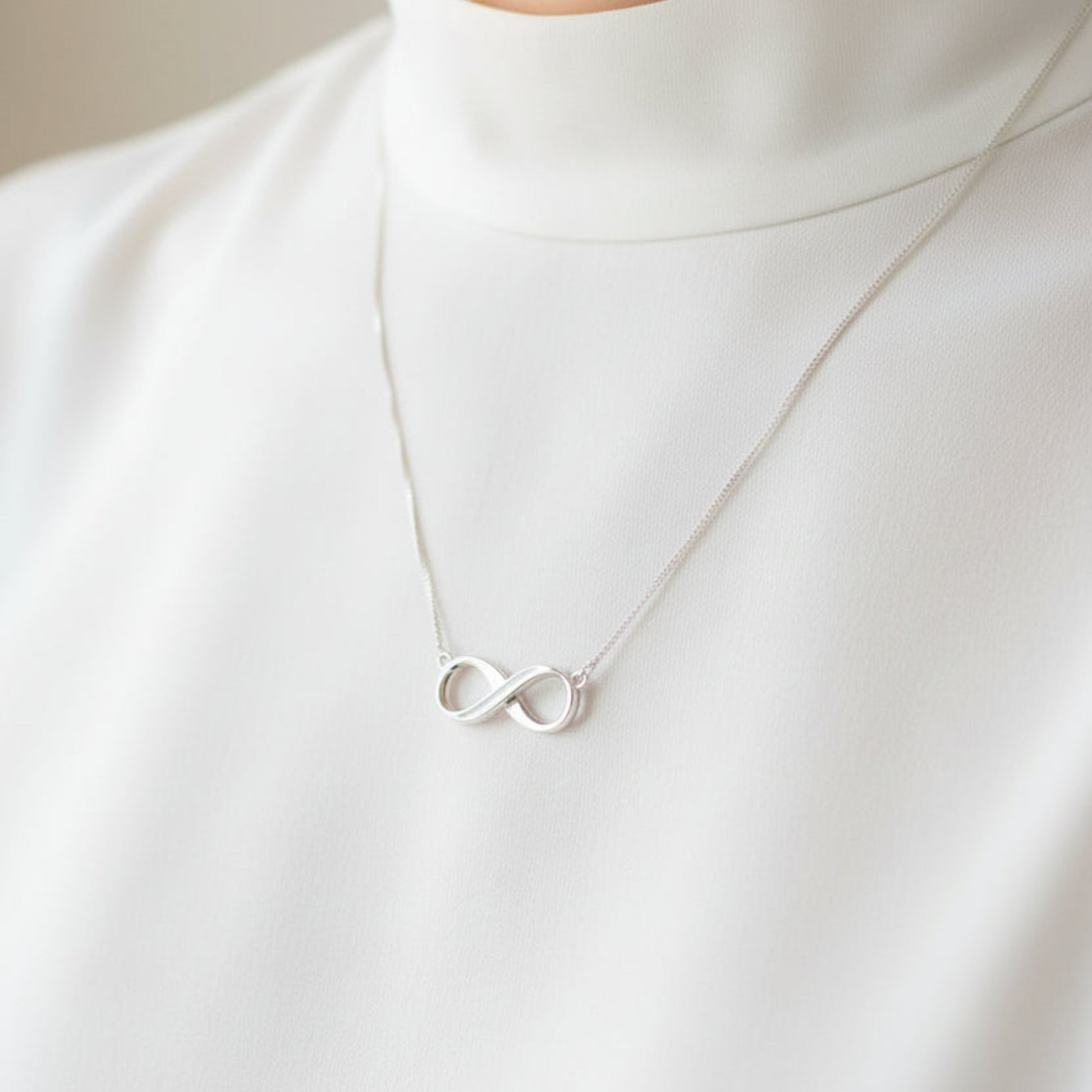 silver ashes infinity necklace on neck handcrafted in rossendale