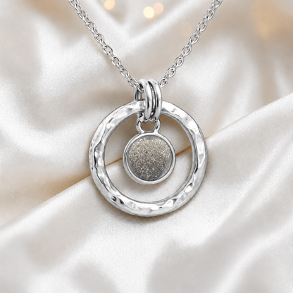 Natural ash hammered hollow circle sterling silver memorial pendant, handcrafted in Lancashire UK by Keepsake Memorial Jewellery
