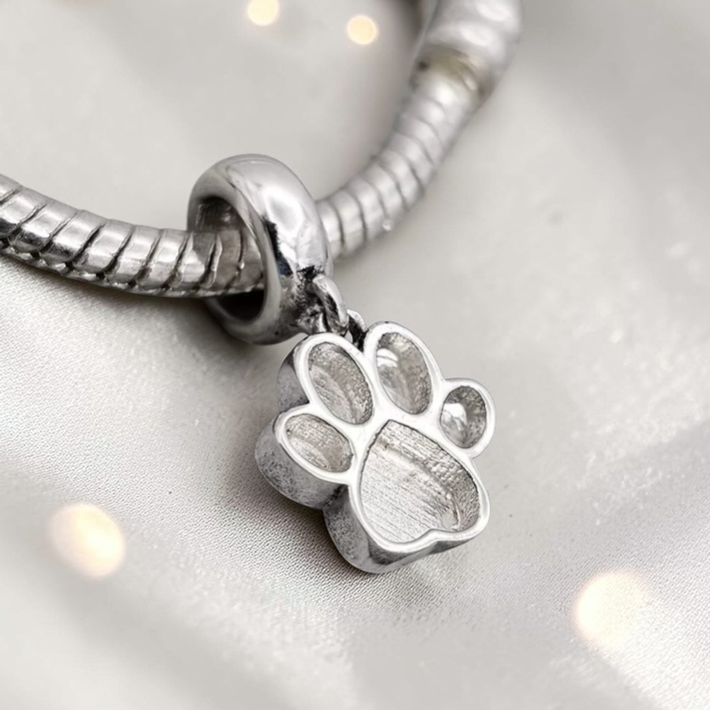 silver memorial paw charm, handcrafted in uj