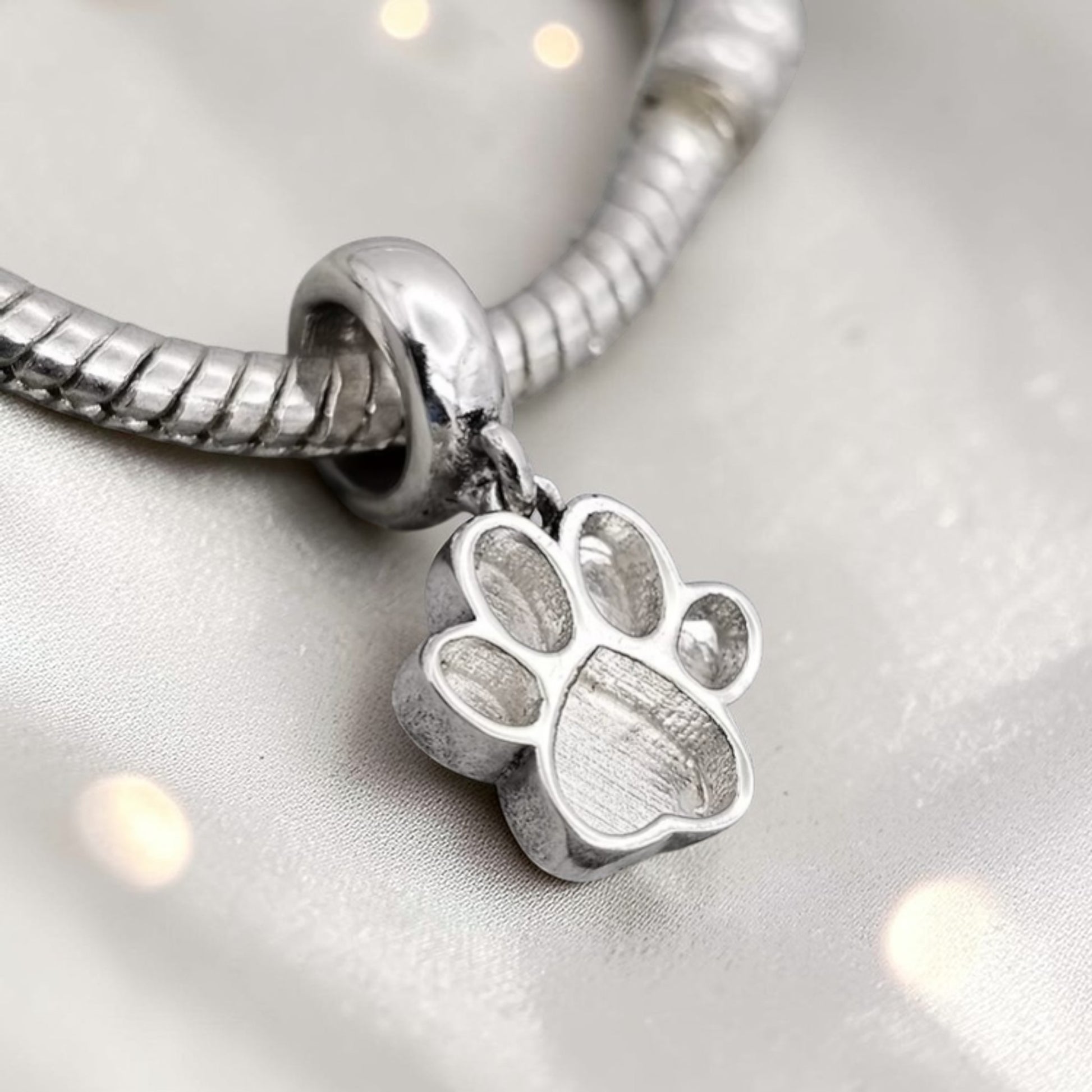 silver memorial paw charm, handcrafted in uj