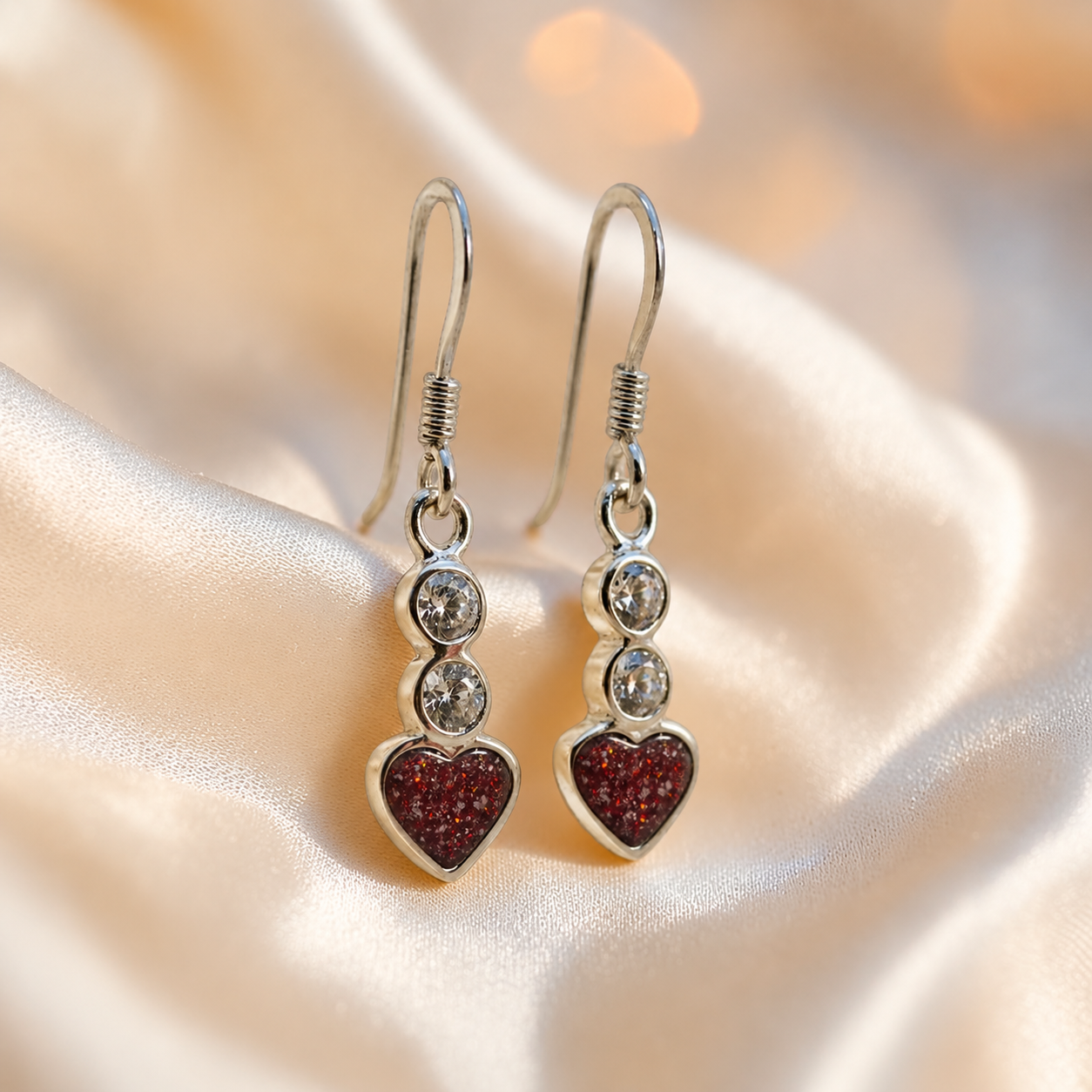 Pleione Earrings — silver heart drop ashes memorial earrings in Ruby Red resin, handcrafted in Lancashire, UK