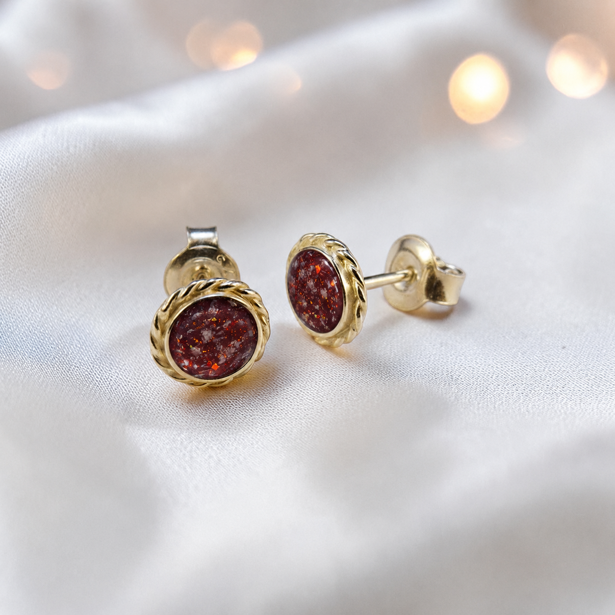 Eterna memorial stud earrings in Ruby Red opal — sterling silver rope edge, handcrafted in Lancashire, UK