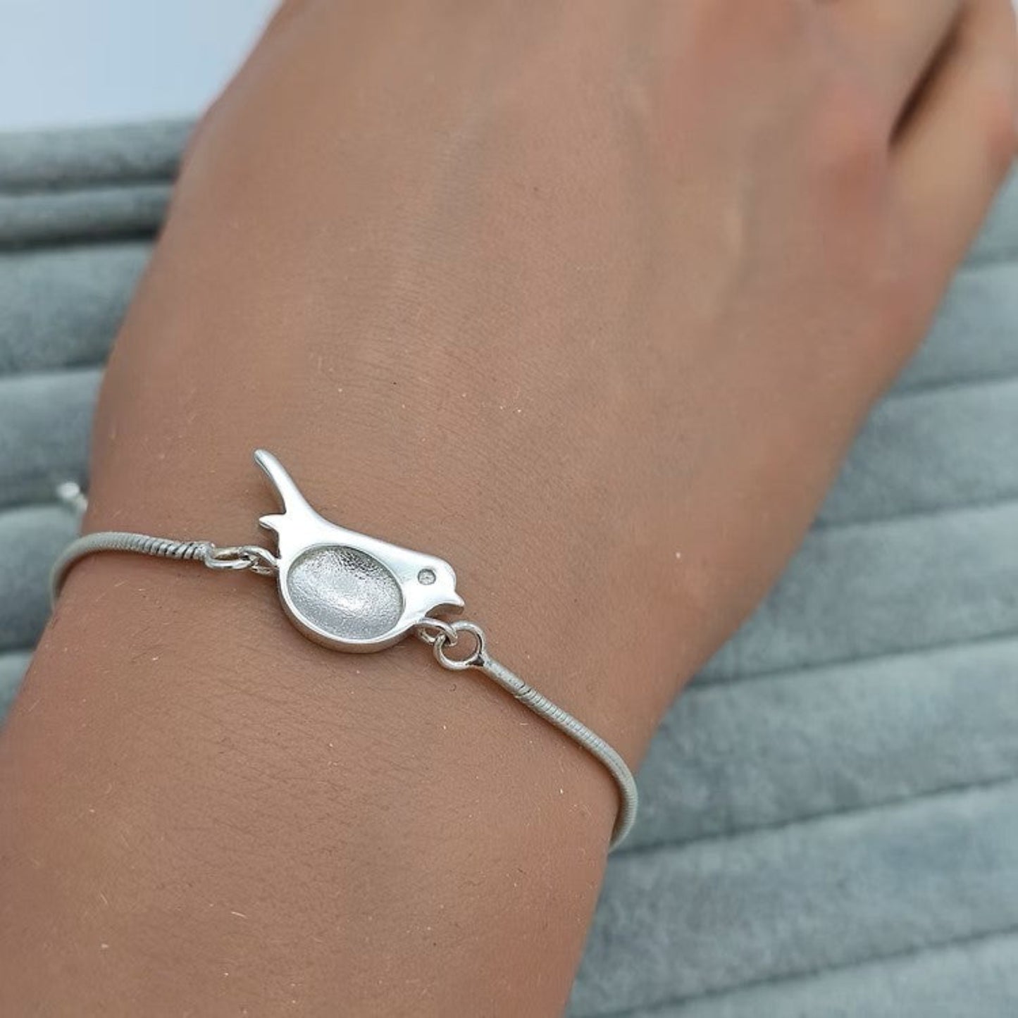 Robin Bracelet — silver robin ashes memorial bracelet worn on wrist, handcrafted in Lancashire, UK