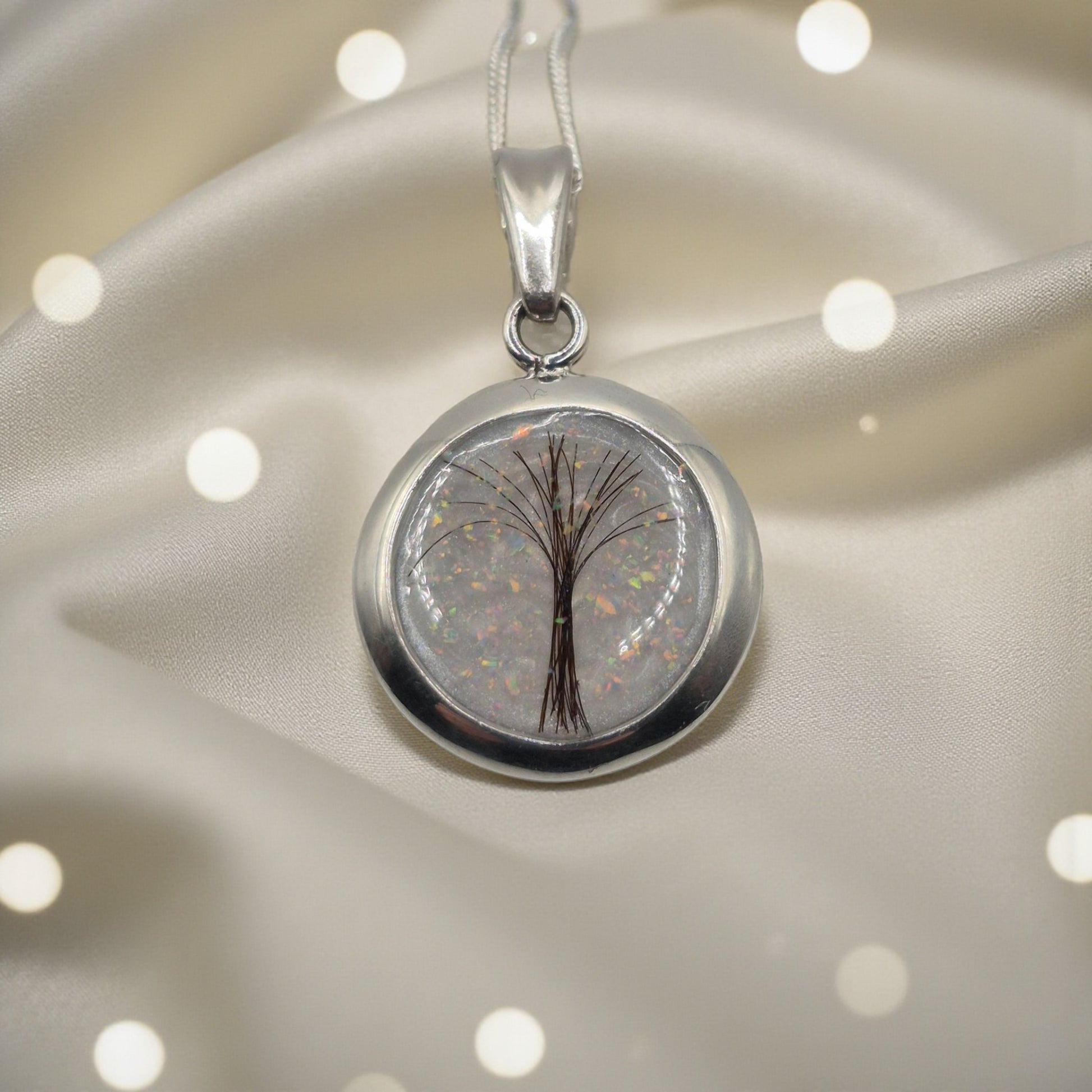round memorial pendant containing hair, handcrafted in lancashire
