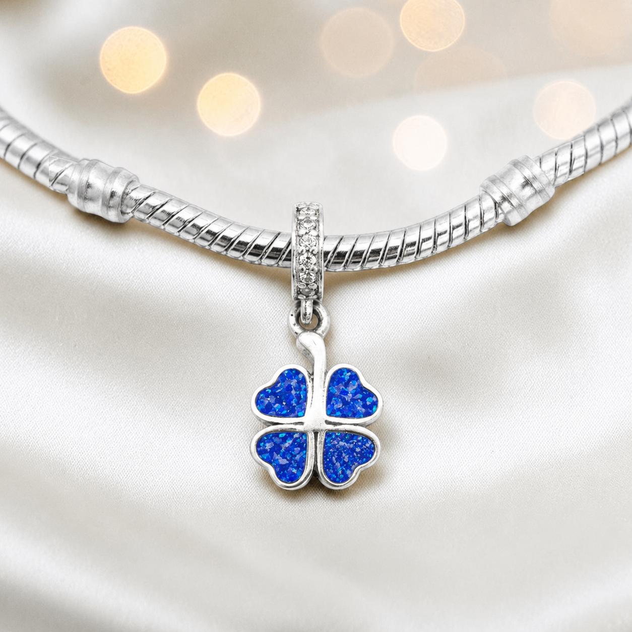 Royal blue sterling silver clover dangle ashes memorial charm, handcrafted in Lancashire by keepsake memorial