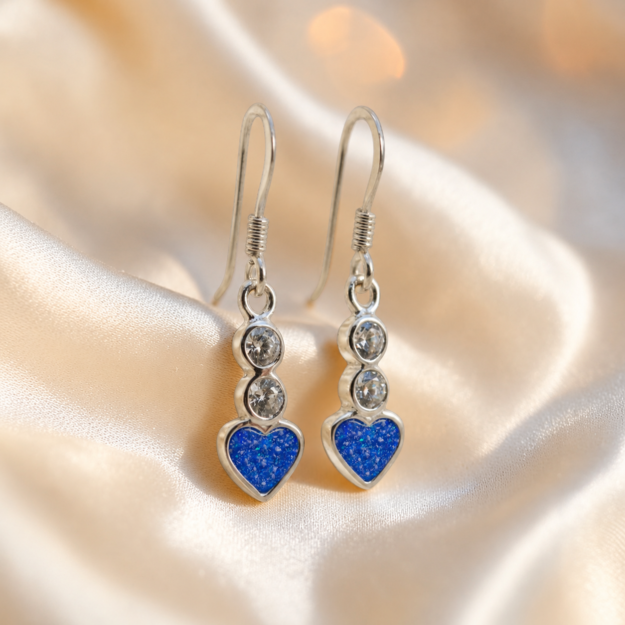 Pleione Earrings — silver heart drop ashes memorial earrings in Royal Blue resin, handcrafted in Lancashire, UK