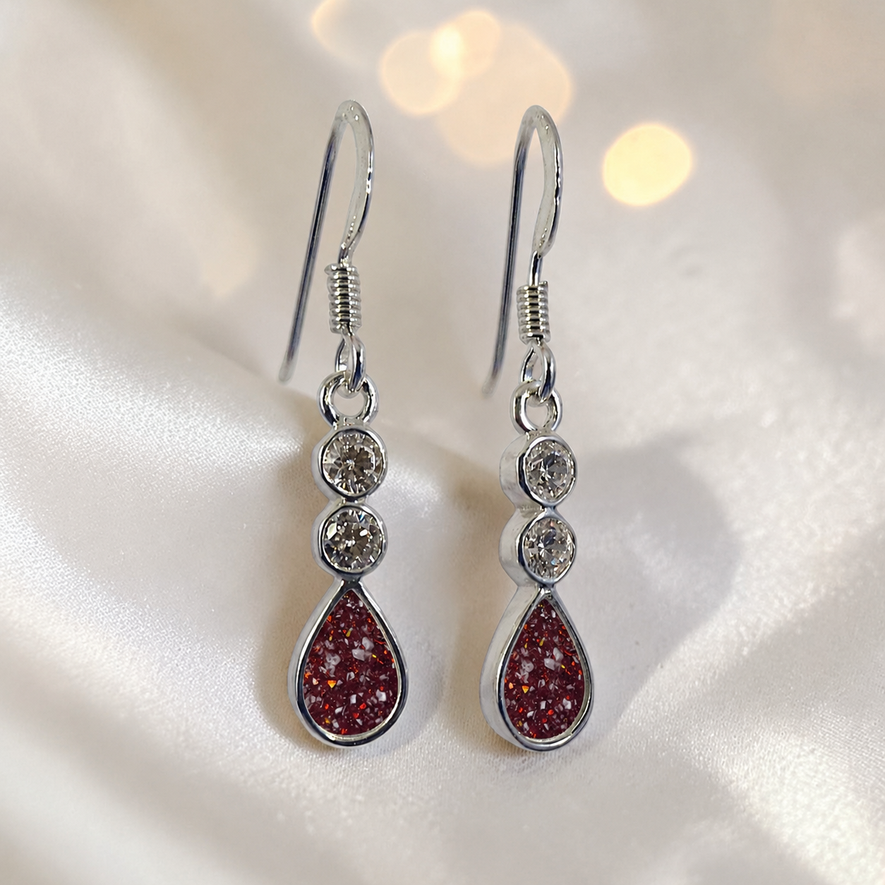 Acrux Earrings — silver pear drop ashes memorial earrings in Ruby Red resin, handcrafted in Lancashire, UK