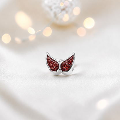 Ruby red sterling silver angel wing ashes memorial charm, handcrafted in Lancashire by keepsake memorial