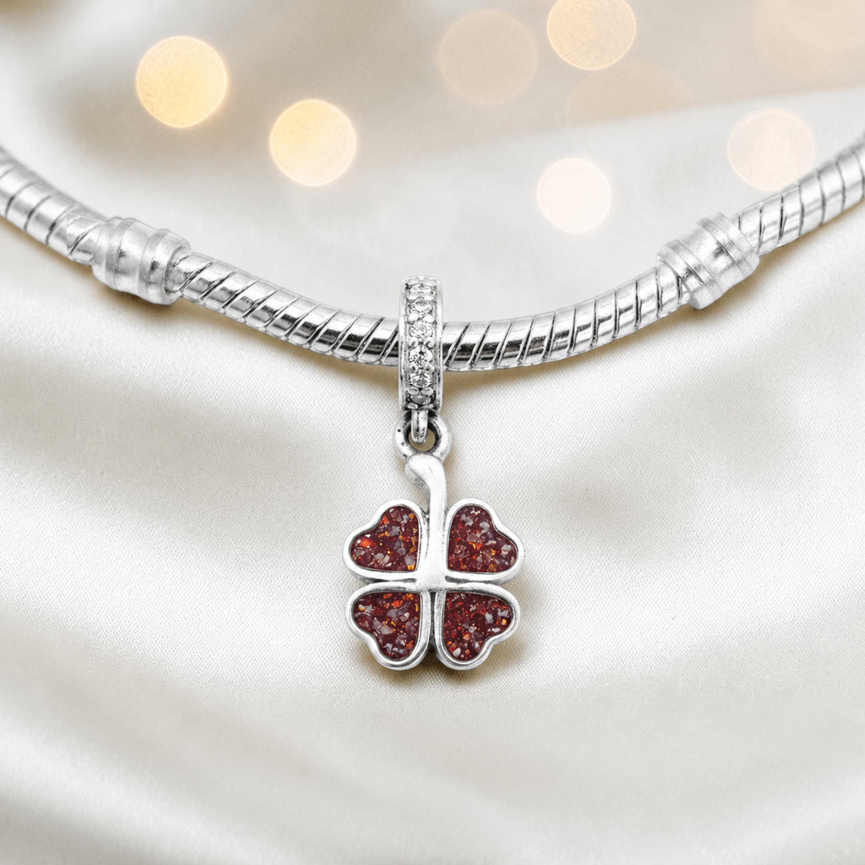 Ruby red sterling silver clover dangle ashes memorial charm, handcrafted in Lancashire by keepsake memorial