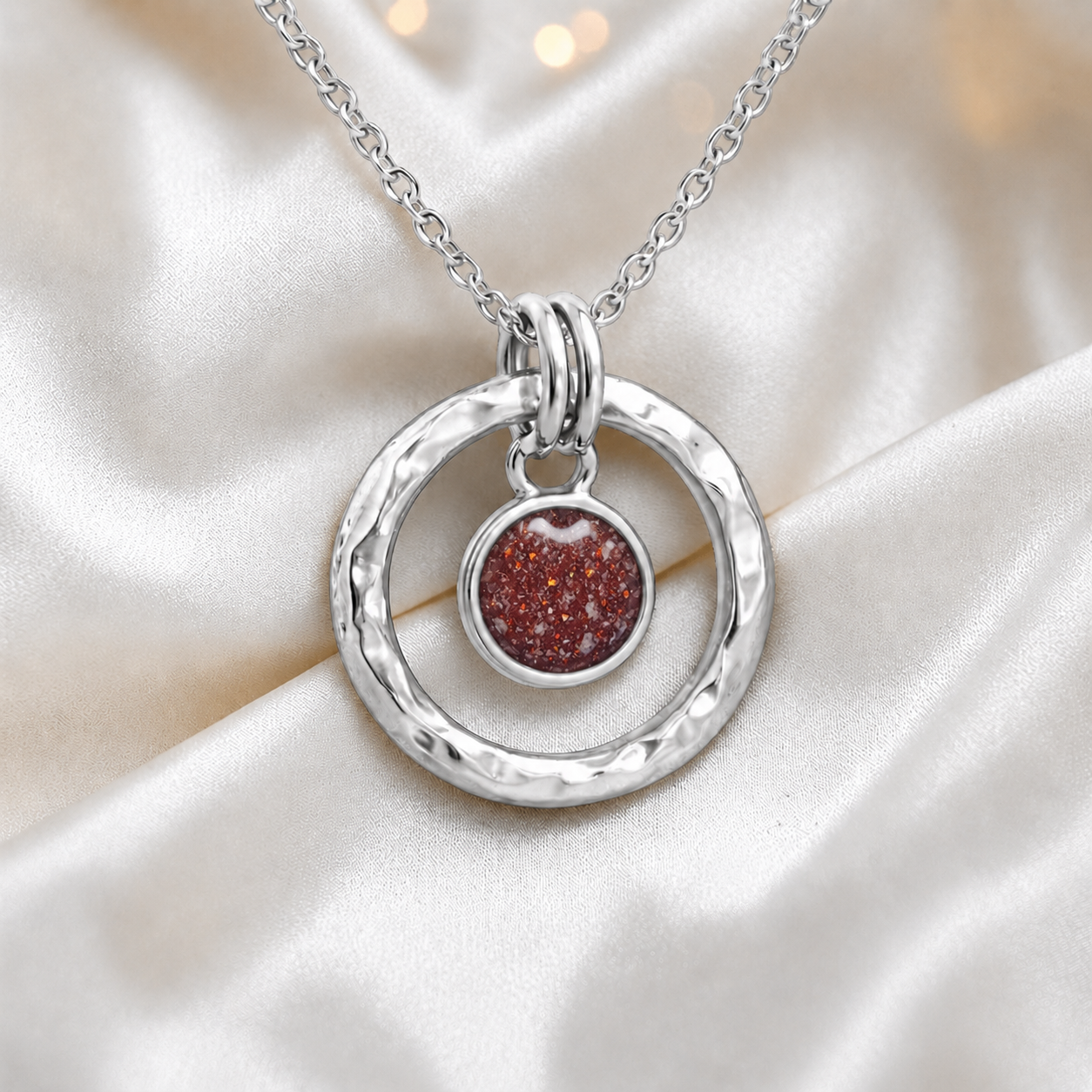 Ruby red hammered hollow circle sterling silver memorial pendant, handcrafted in Lancashire UK by Keepsake Memorial Jewellery
