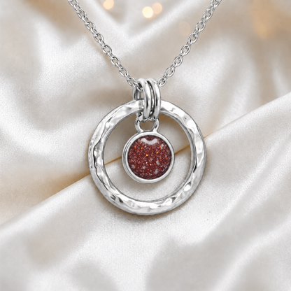 Ruby red hammered hollow circle sterling silver memorial pendant, handcrafted in Lancashire UK by Keepsake Memorial Jewellery
