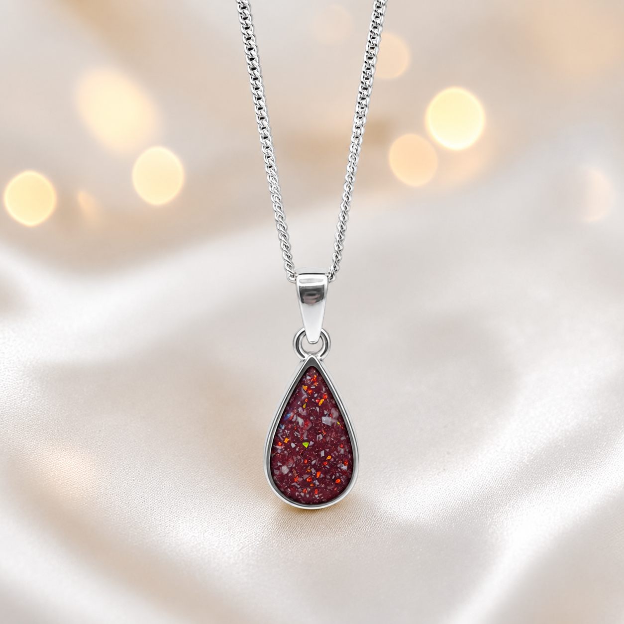 Silver Vega teardrop memorial pendant in Ruby Red, handcrafted in Lancashire 