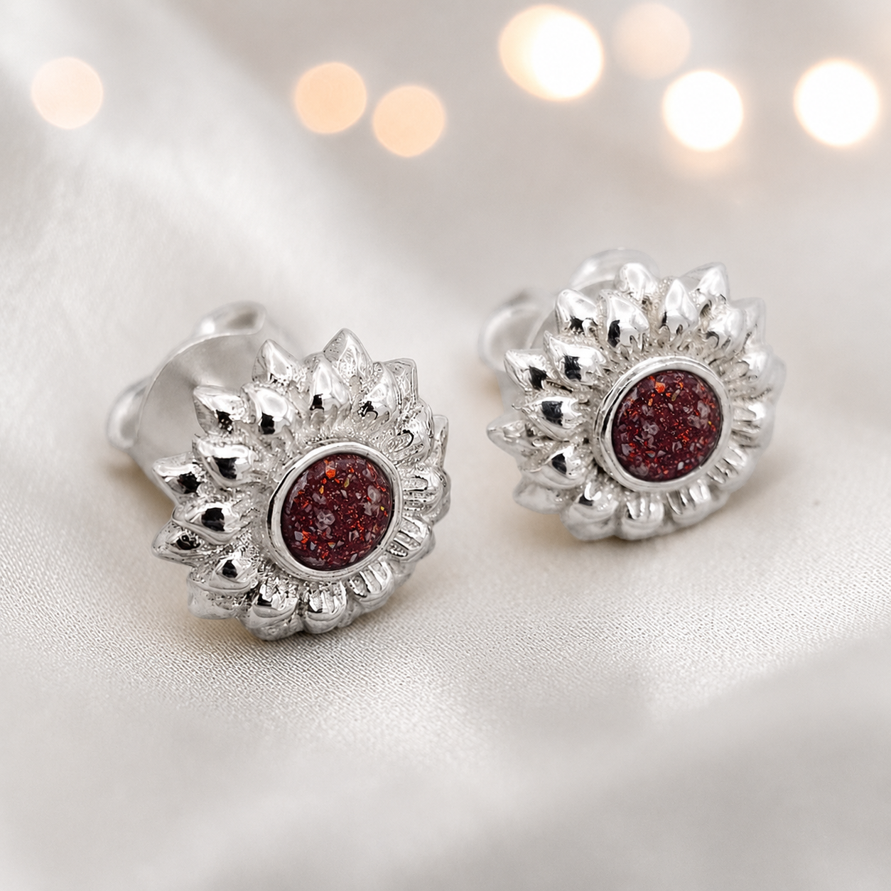 Flora Earrings — silver sunflower ashes memorial stud earrings in Ruby Red resin, handcrafted in Lancashire, UK