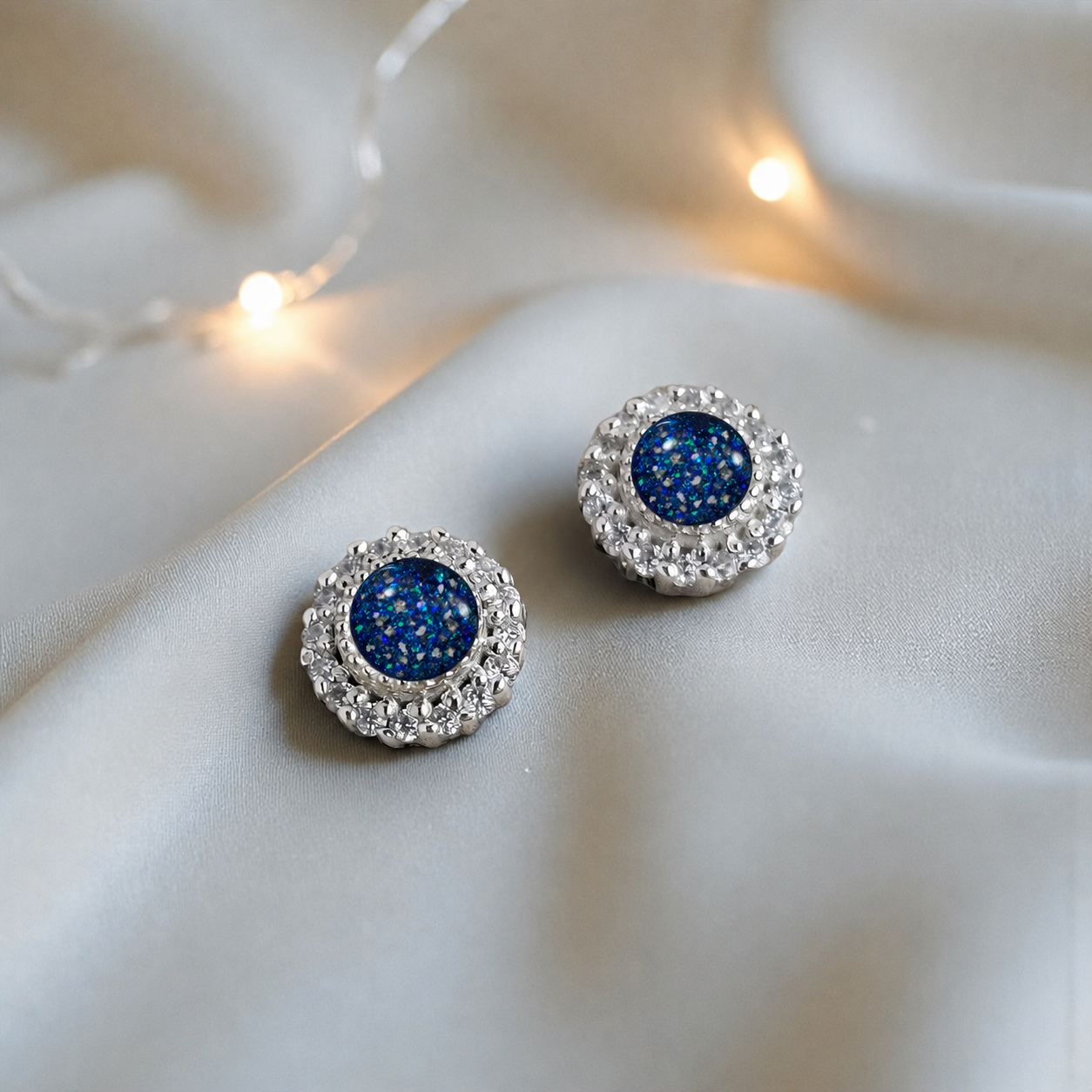 Halo's memorial stud earrings in Sapphire Glow opal — sterling silver, handcrafted in Lancashire, UK