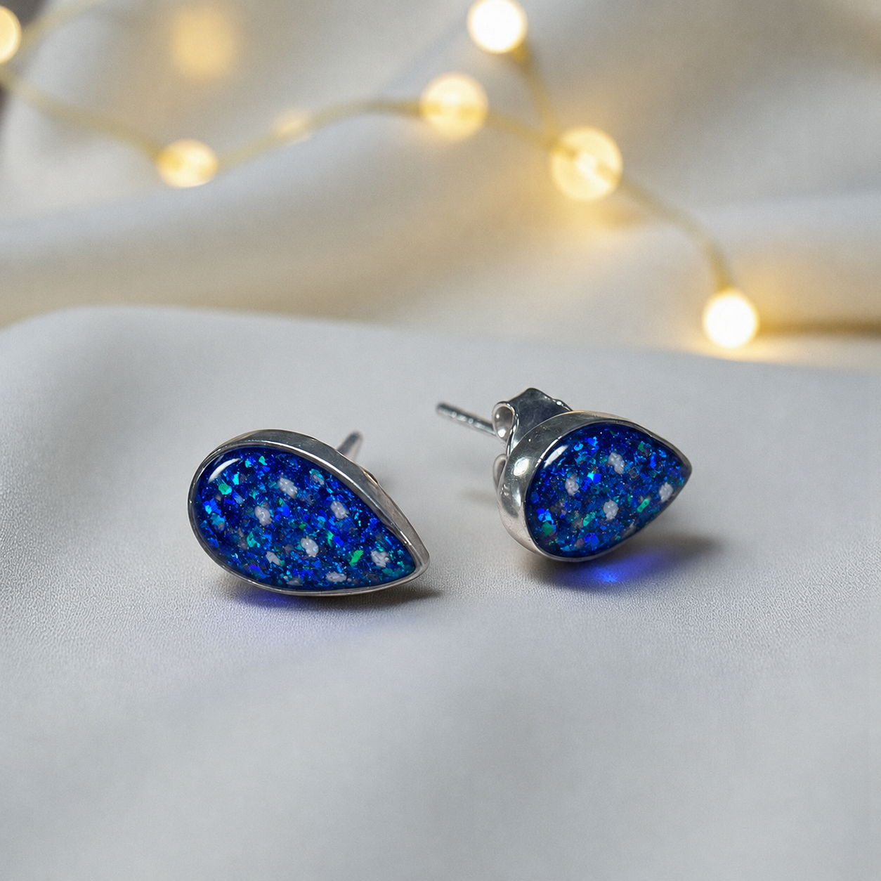Pure Radiance memorial earrings in Sapphire Glow opal — sterling silver, handcrafted in Lancashire, UK