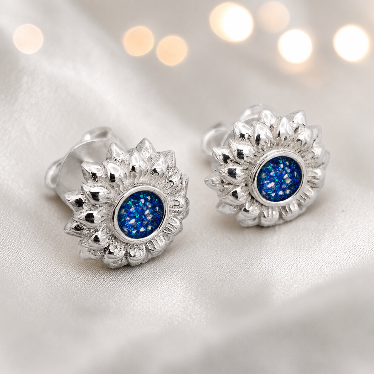 Flora Earrings — silver sunflower ashes memorial stud earrings in Sapphire Glow resin, handcrafted in Lancashire, UK