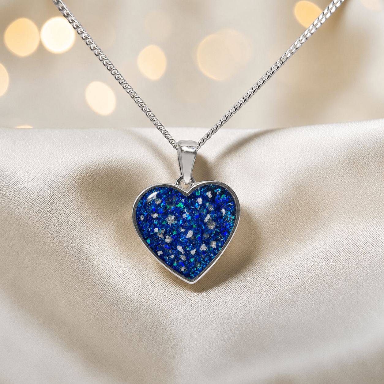 Silver Betel heart ashes memorial pendant in Sapphire glow, handcrafted in Lancashire UK