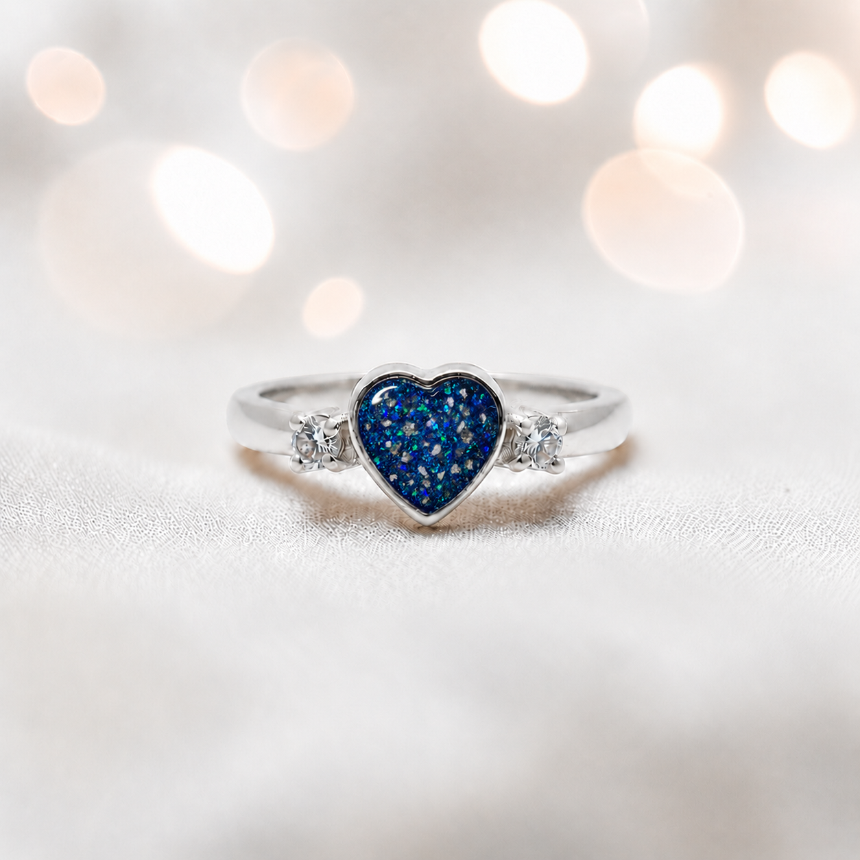 Valentina Ring — silver heart ashes memorial ring, in sapphire glow, handcrafted in the UK