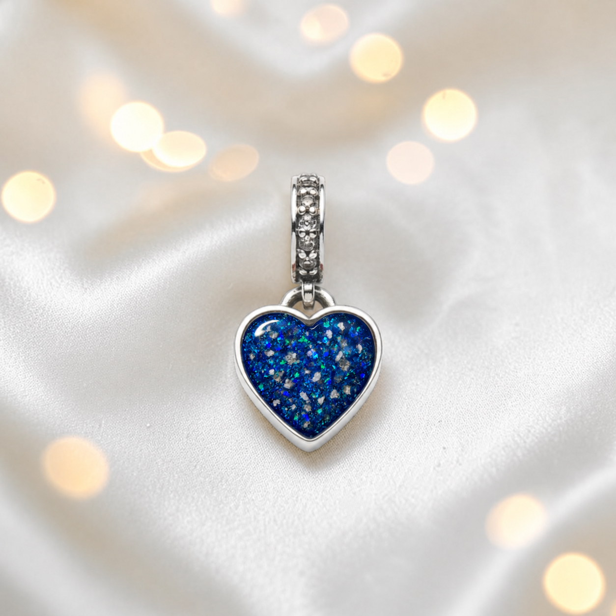 Sapphire glow sterling silver heavens heart ashes memorial dangle  charm, handcrafted in Lancashire by keepsake memorial