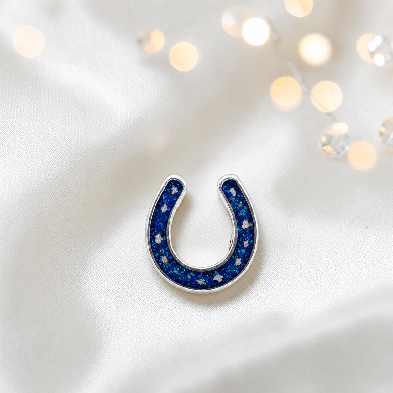 Maverick horseshoe ashes charm, in sapphire glow, handcrafted in Lancashire UK - by Keepsake Memorial Jewellery 