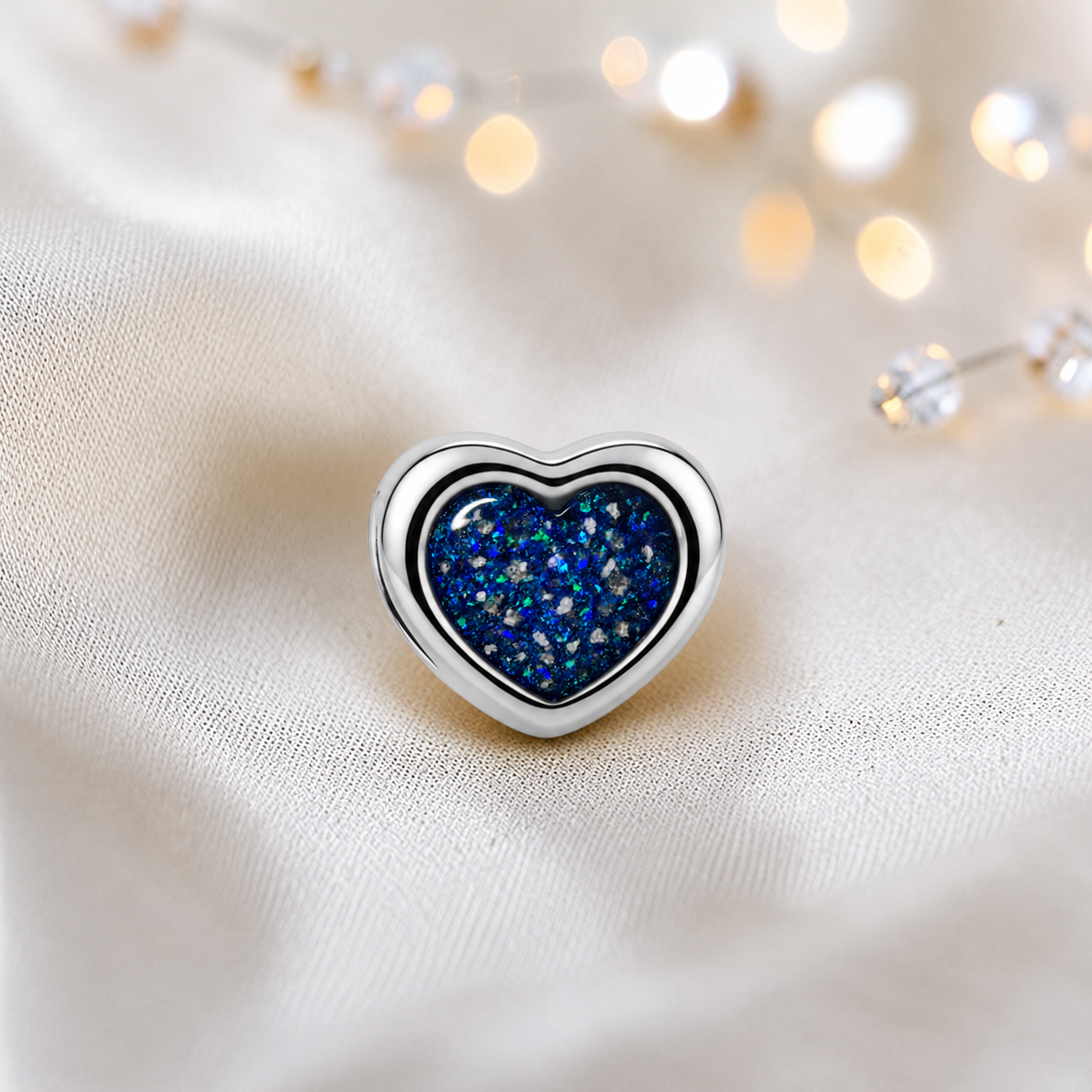 Sapphire glow sterling silver peaceful heart ashes memorial charm, handcrafted in Lancashire by keepsake memorial