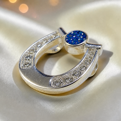 Sparkle horseshoe ashes pendant in sapphire glow,  handcrafted in Lancashire UK - by Keepsake Memorial Jewellery