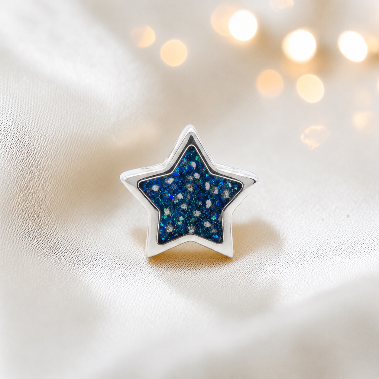 Sapphire glow sterling silver star ashes memorial charm, handcrafted in Lancashire by keepsake memorial