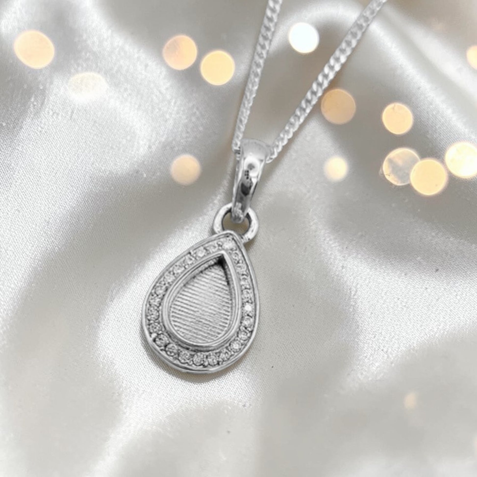 silver pear shaped ashes pendant with cz stones 