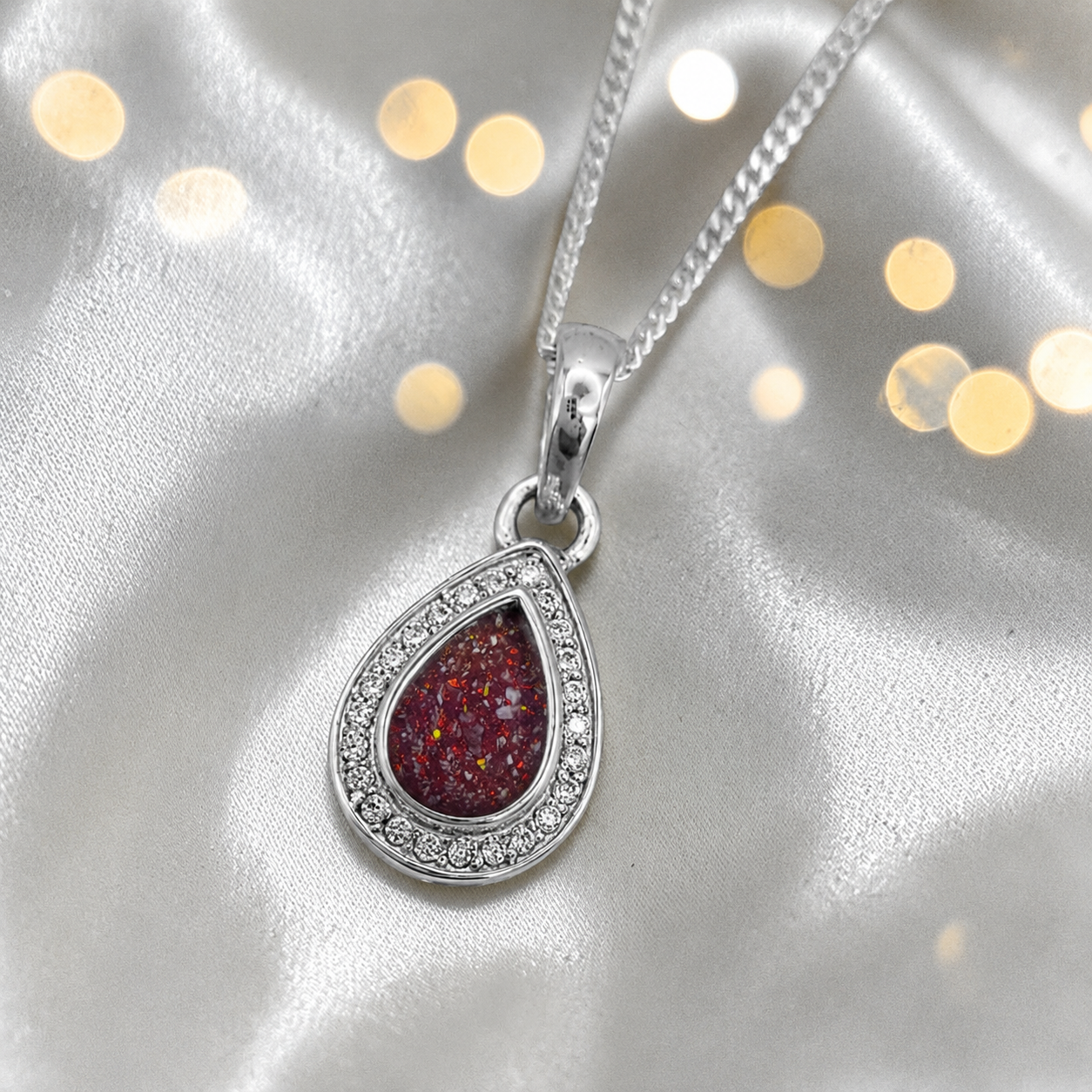 seraph glow pear shaped ashes pendant with CZ in ruby red, handcrafted in Lancashire UK