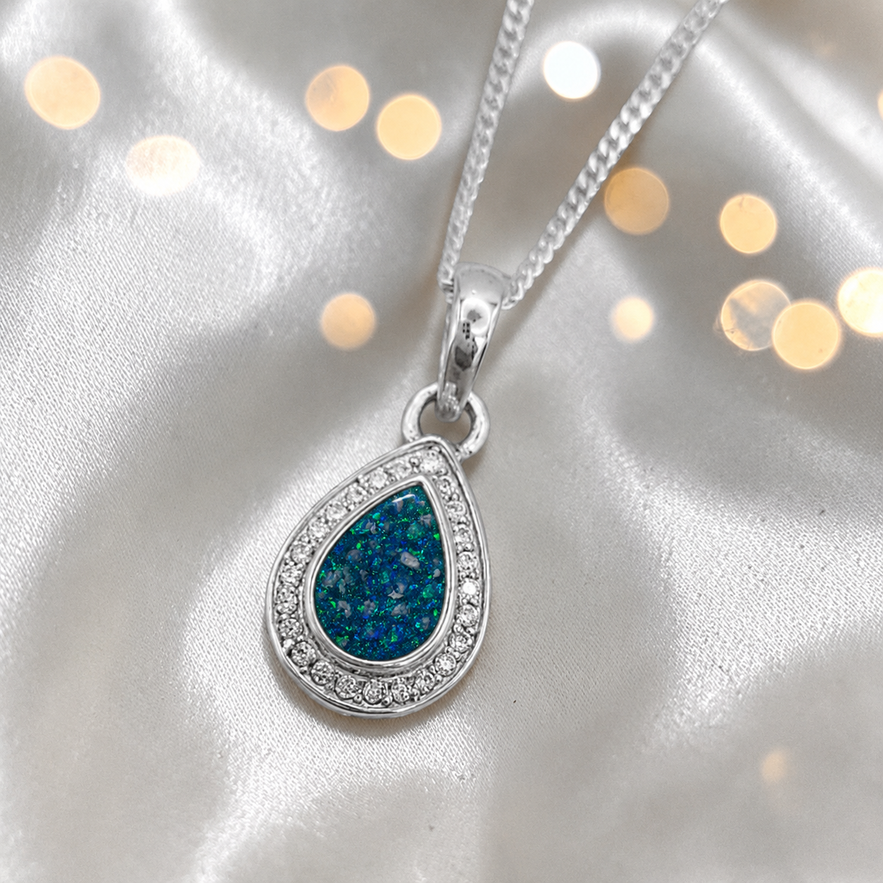 seraph glow pear shaped ashes pendant with CZ in teal mist, handcrafted in Lancashire UK