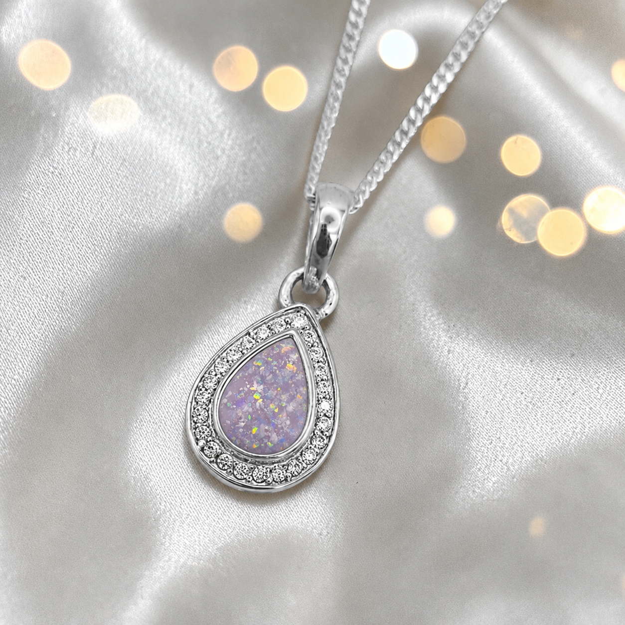 seraph glow pear shaped ashes pendant with CZ in unicorn purple, handcrafted in Lancashire UK