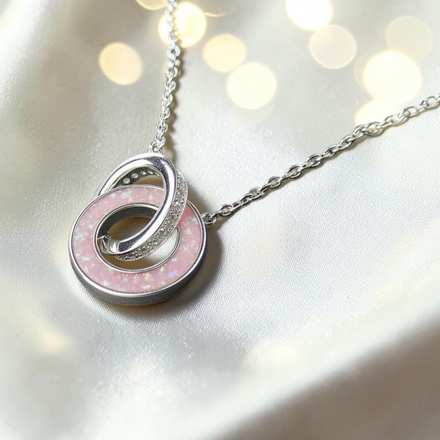 Eternal Embrace Pendant in 925 sterling silver — two interlocking rings with cubic zirconia. Handcrafted memorial jewellery, made in Lancashire Uk